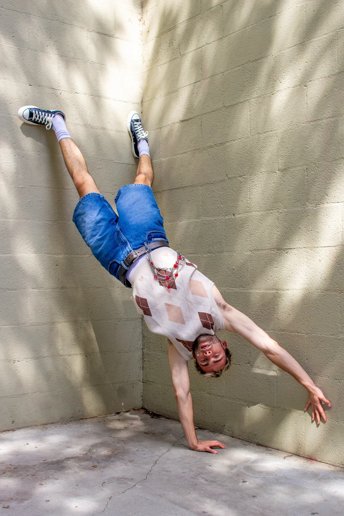 Jeffrey balancing upside down outdoors on one hand